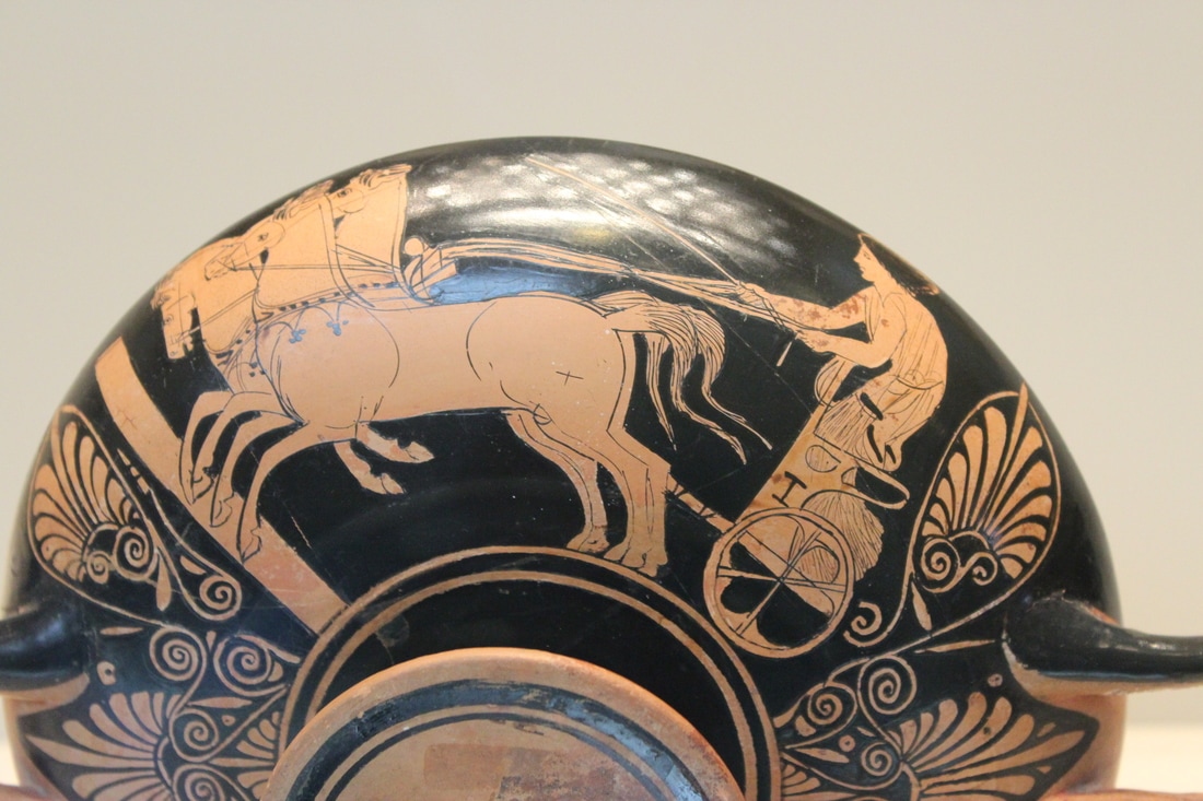 Greek vase with female driving a 4-horse chariot, possibly Kyniska. 4th century BCE